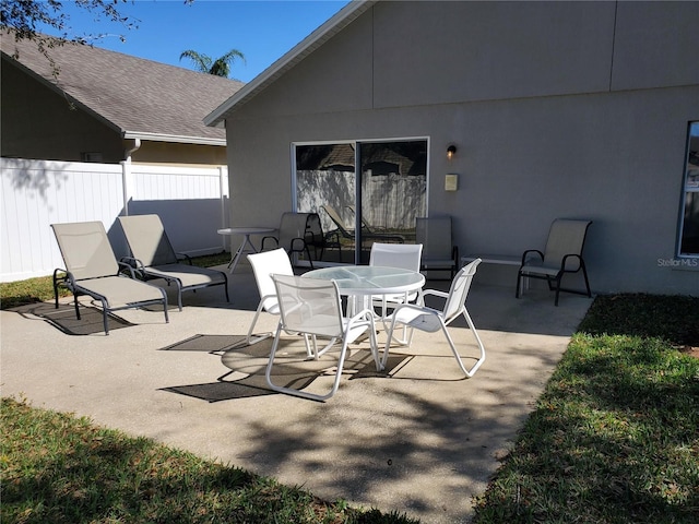 view of patio / terrace featuring outdoor dining space and fence