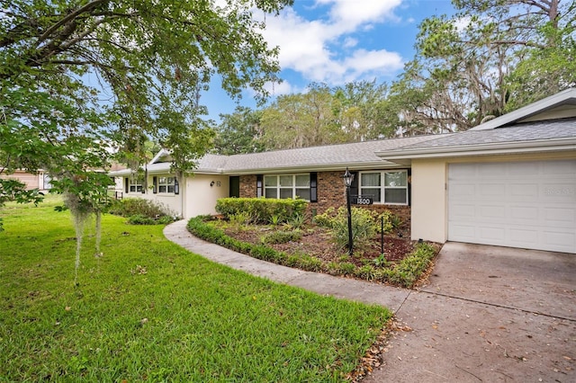 ranch-style house with brick siding, concrete driveway, a front yard, stucco siding, and an attached garage