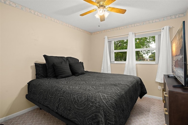 bedroom featuring carpet flooring, ceiling fan, a textured ceiling, and baseboards