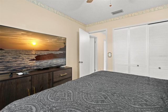 bedroom with visible vents, a closet, and ceiling fan