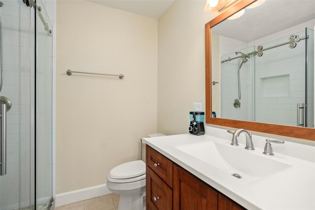 full bathroom with toilet, a shower stall, tile patterned flooring, baseboards, and vanity