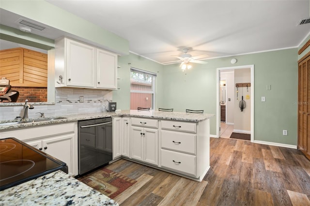 kitchen featuring dishwashing machine, a peninsula, white cabinets, a ceiling fan, and a sink