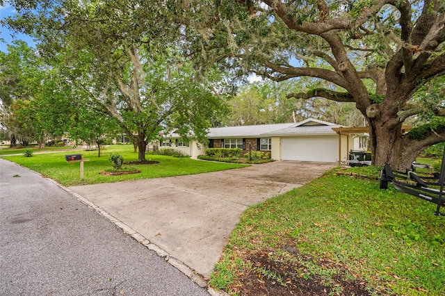 single story home featuring a front lawn, an attached garage, driveway, and stucco siding