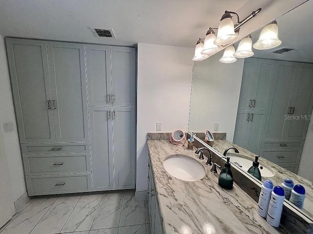 bathroom featuring vanity, an inviting chandelier, visible vents, and marble finish floor