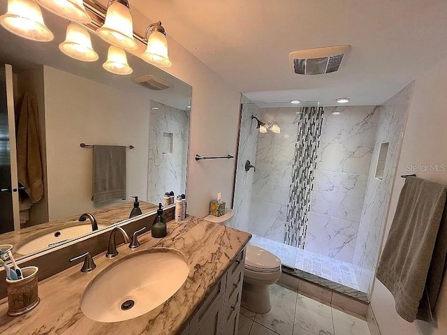 bathroom featuring vanity, toilet, visible vents, and walk in shower