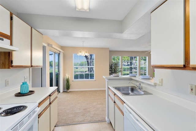 kitchen with light countertops, light carpet, a chandelier, and a sink