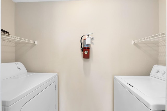 laundry room with laundry area and washing machine and clothes dryer