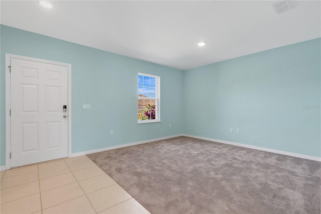 empty room with tile patterned flooring, recessed lighting, baseboards, and visible vents