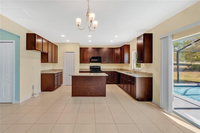 kitchen with a kitchen island, recessed lighting, light tile patterned flooring, black appliances, and a sink