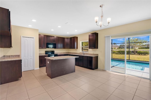 kitchen with black appliances, light tile patterned floors, recessed lighting, and a kitchen island