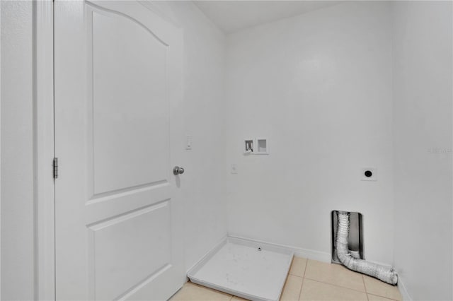 washroom with light tile patterned flooring, baseboards, hookup for an electric dryer, hookup for a washing machine, and laundry area