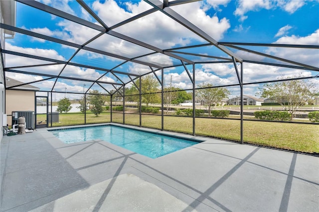 outdoor pool featuring a lanai, a patio area, cooling unit, and a yard