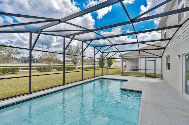 outdoor pool featuring glass enclosure, a patio, and a lawn