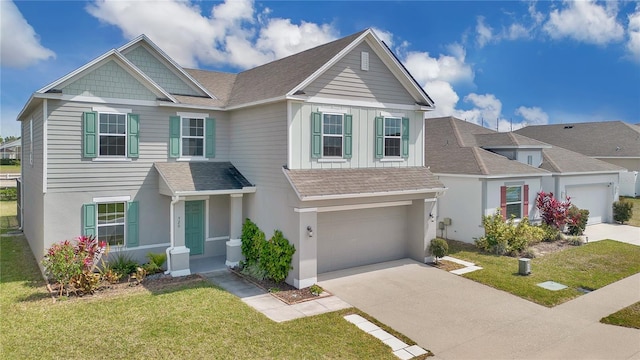 craftsman-style house with concrete driveway, an attached garage, a front lawn, and a shingled roof