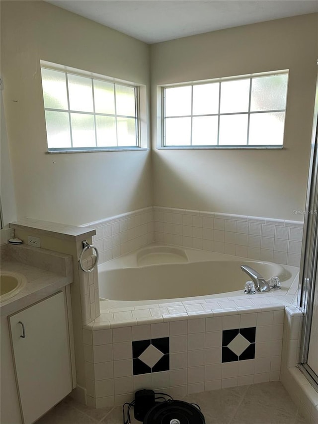 bathroom featuring tile patterned flooring, a bath, vanity, and a shower with door