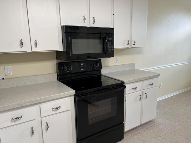 kitchen with white cabinets, light countertops, and black appliances