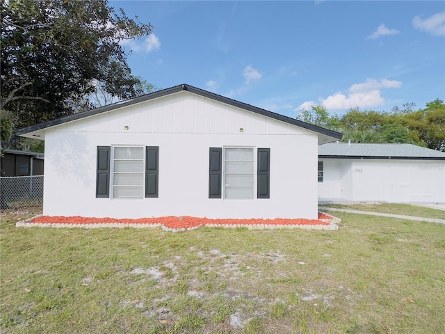 view of home's exterior featuring a yard and fence