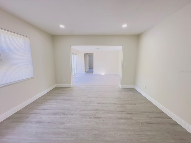 unfurnished room featuring recessed lighting, baseboards, and light wood finished floors