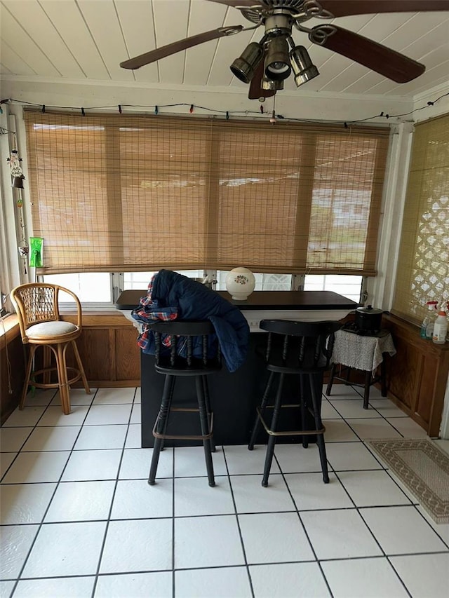 sunroom / solarium with a ceiling fan