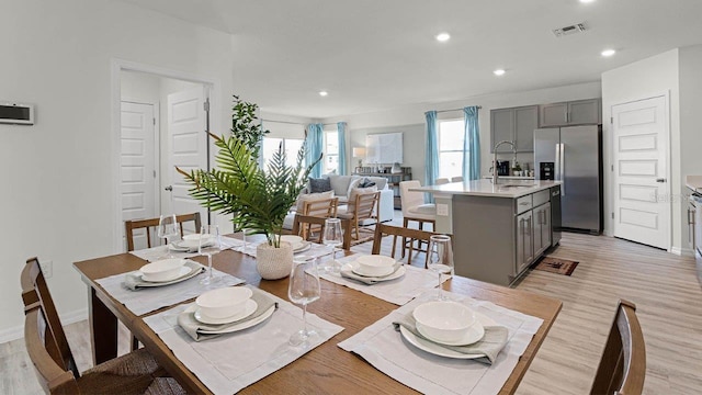 dining room with recessed lighting, visible vents, light wood finished floors, and baseboards