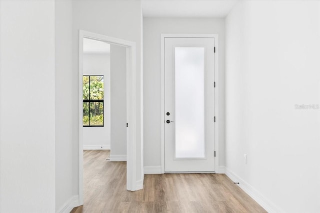 foyer entrance with baseboards and light wood-type flooring