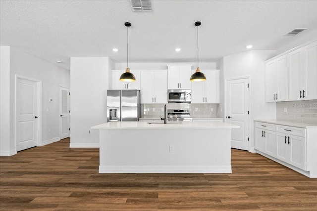 kitchen featuring dark wood-style floors, visible vents, appliances with stainless steel finishes, and light countertops