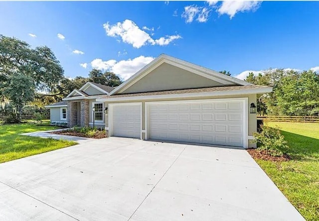 single story home featuring an attached garage, a front lawn, fence, stucco siding, and driveway