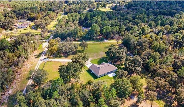 birds eye view of property with a view of trees