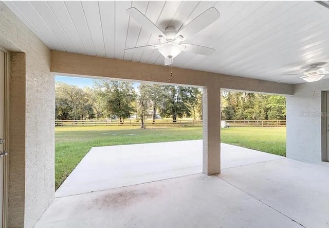 view of patio / terrace with ceiling fan and fence