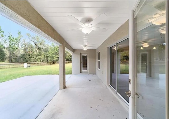 view of patio / terrace featuring ceiling fan and fence