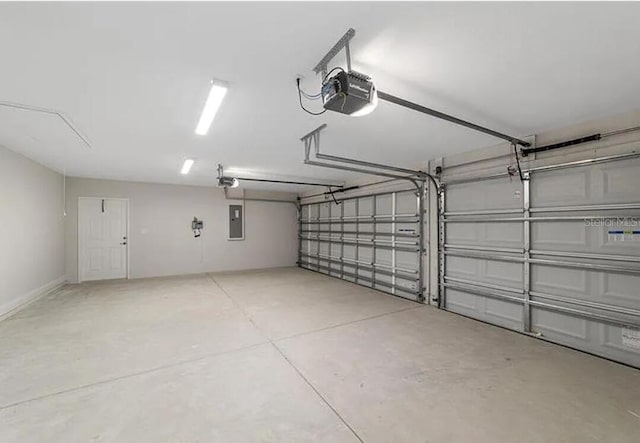 garage with electric panel and a garage door opener