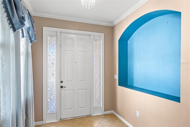 foyer entrance featuring tile patterned floors, baseboards, a wealth of natural light, and ornamental molding