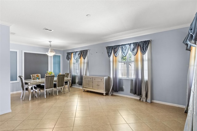 dining area with light tile patterned floors, visible vents, and crown molding