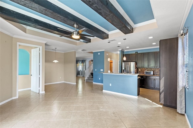 kitchen featuring light tile patterned floors, dark brown cabinetry, stainless steel fridge, and crown molding