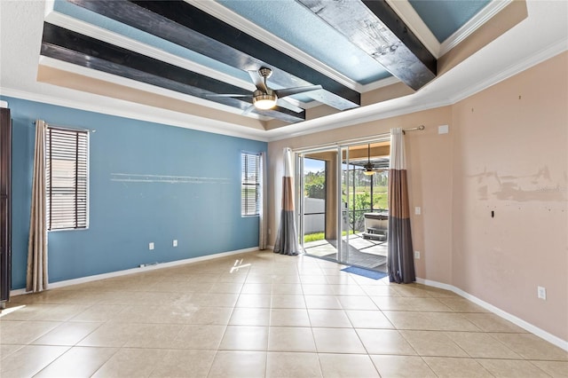 tiled empty room with crown molding, a raised ceiling, and ceiling fan