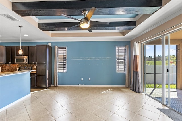 kitchen with light tile patterned floors, stainless steel microwave, dark brown cabinetry, and visible vents