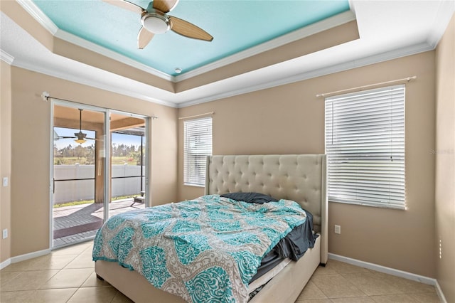 bedroom featuring baseboards, access to exterior, crown molding, a raised ceiling, and tile patterned floors