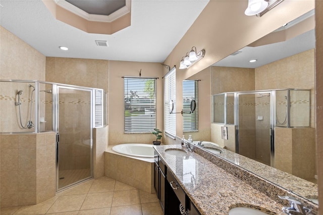 full bath featuring a sink, a bath, a shower stall, and tile patterned flooring