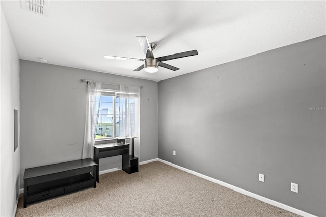 miscellaneous room with visible vents, baseboards, ceiling fan, and carpet floors