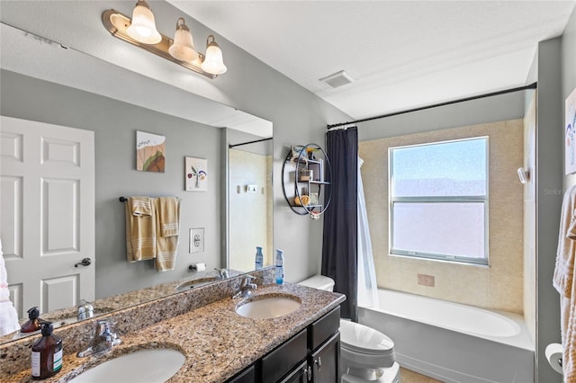 bathroom featuring visible vents, toilet, and a sink