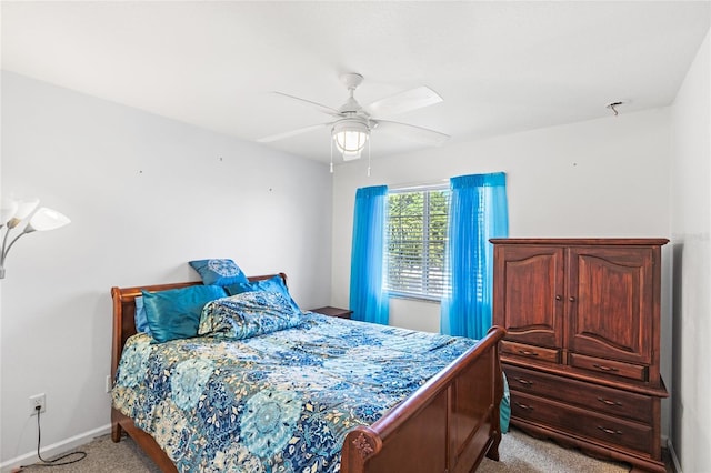 bedroom featuring a ceiling fan, light colored carpet, and baseboards