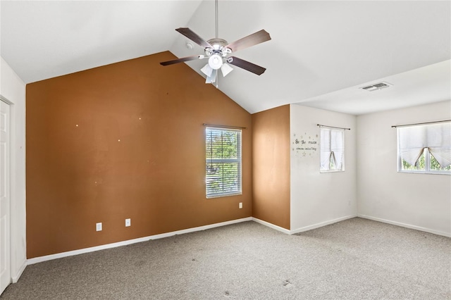 empty room featuring visible vents, baseboards, vaulted ceiling, carpet flooring, and a ceiling fan