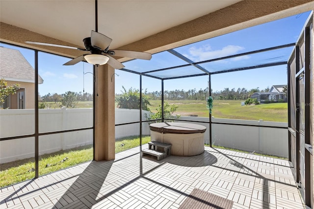 sunroom / solarium with a ceiling fan