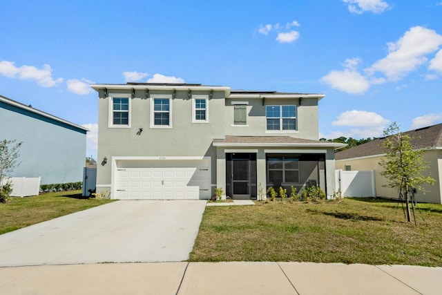 traditional home featuring solar panels, concrete driveway, a front yard, stucco siding, and an attached garage