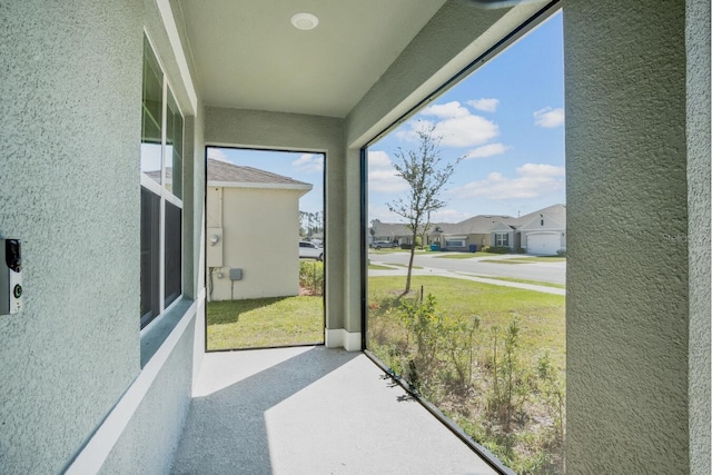 sunroom / solarium featuring a residential view