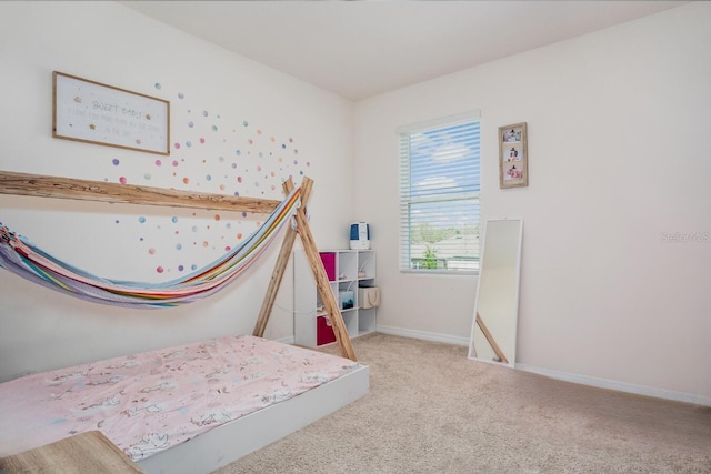 bedroom with baseboards and carpet floors