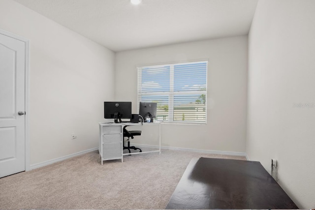 office area with light colored carpet and baseboards