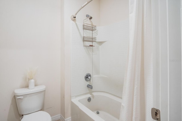 bathroom featuring shower / bath combo with shower curtain and toilet