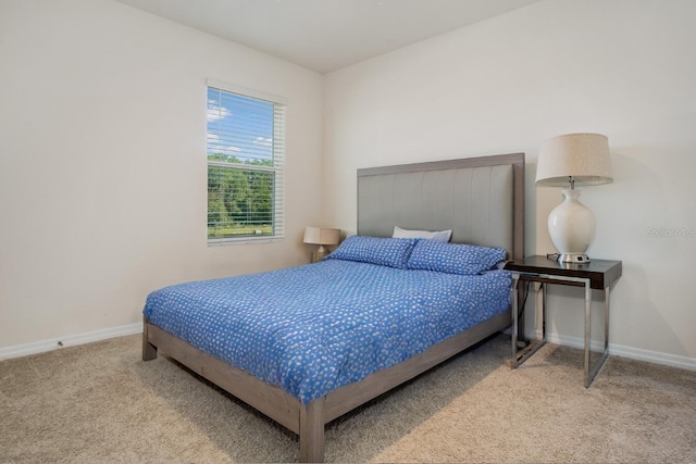 carpeted bedroom featuring baseboards