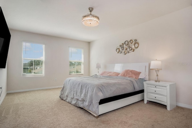 bedroom featuring baseboards and carpet floors